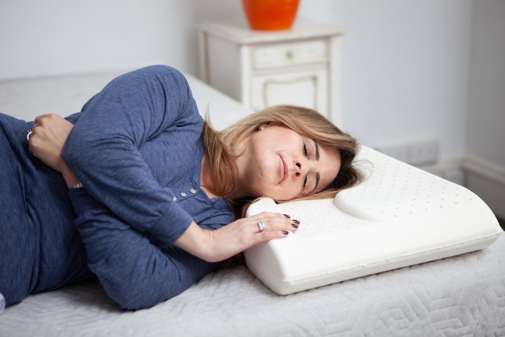 woman sleeping on pillow designed for shoulder pain relief