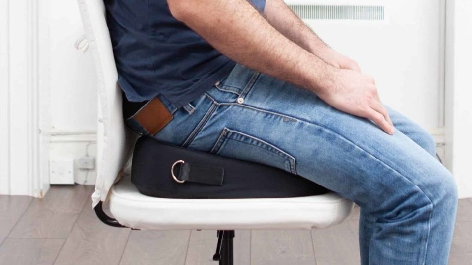 man sitting on a natural latex seat cushion for back pain