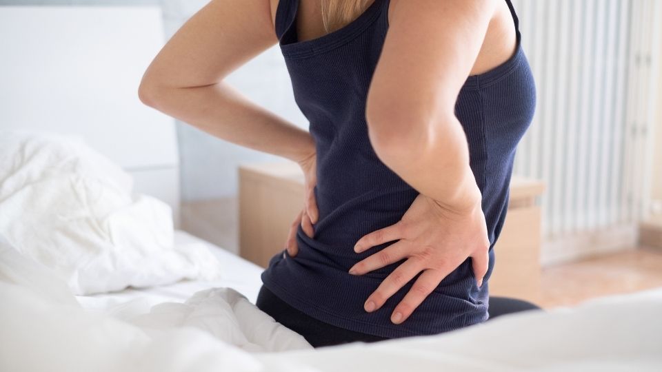 woman seated with back pain