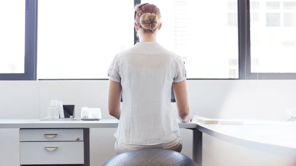 woman sitting on a yoga ball with no back support